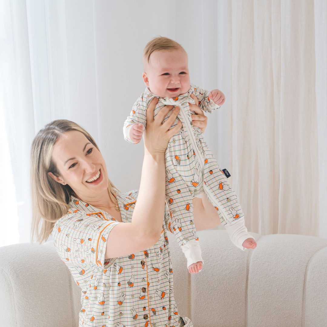 Baby wearing the ZIPSTER x Miffy Checkered Bloom bamboo babygrow