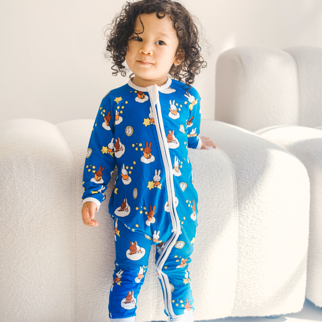 Baby wearing the ZIPSTER x Miffy Starry Sleep bamboo babygrow