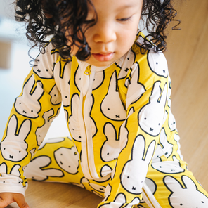 Baby wearing the ZIPSTER x Miffy Hello Yellow bamboo babygrow